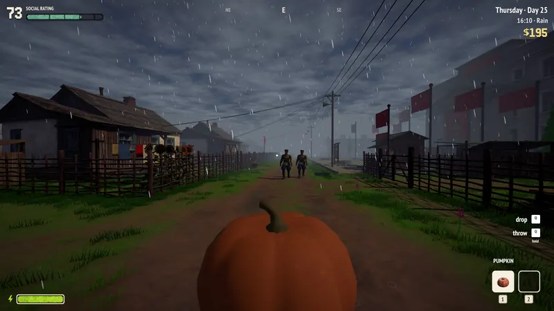 A patrol walks down the village street in the rain.
